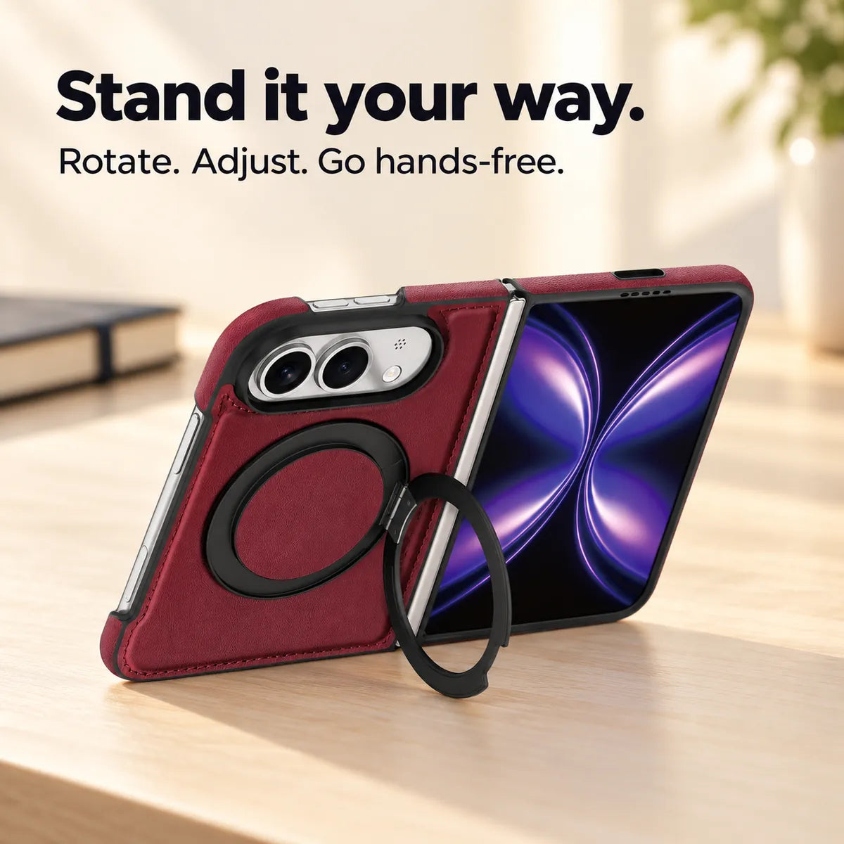 Burgundy folding phone case supported on a light desk by its open black ring stand. #color_Burgundy